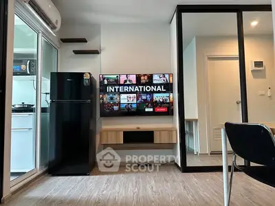 Modern living room with sleek TV setup and compact kitchen area
