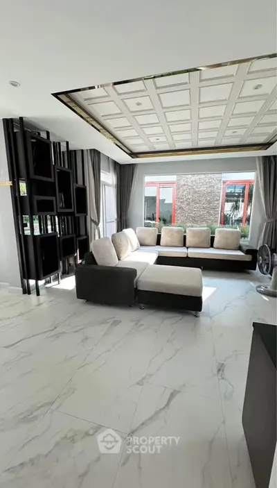 Spacious modern living room with elegant decor and large windows