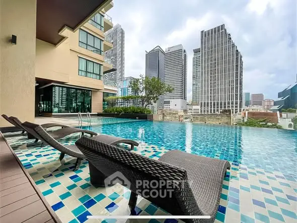 Luxurious rooftop pool with stunning city skyline views and modern lounge chairs.
