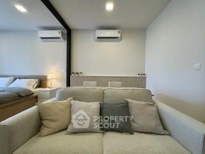 Modern living room with cozy sofa and stylish decor in a contemporary apartment.