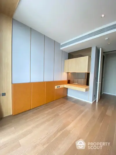 Modern minimalist study room with wooden flooring and built-in desk