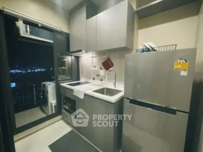Modern kitchen with sleek appliances and city view, perfect for urban living.