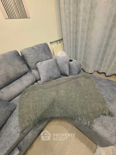 Cozy living room with plush gray sofa and stylish decor