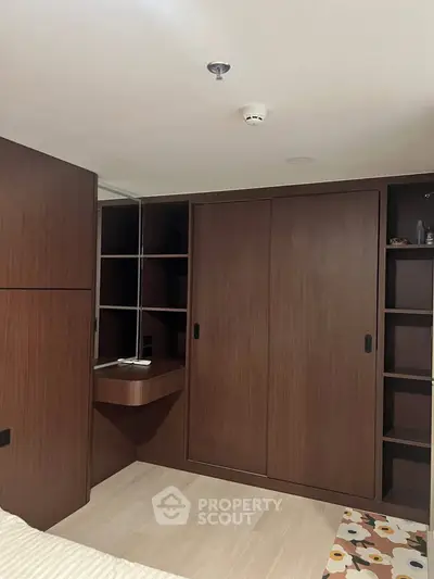 Spacious bedroom with built-in wooden wardrobe and modern design
