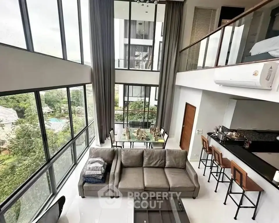 Luxurious modern living room with high ceilings and large windows offering stunning views.