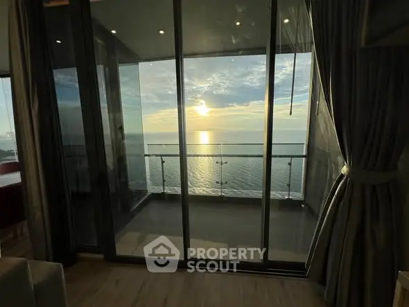 Stunning ocean view from a modern apartment balcony at sunset.