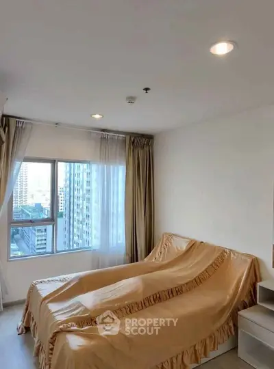 Cozy bedroom with city view and elegant draped bed in modern apartment