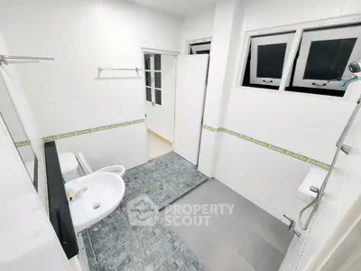 Spacious modern bathroom with dual sinks and sleek tile design