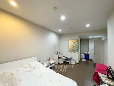 Spacious bedroom with modern decor and ample natural light