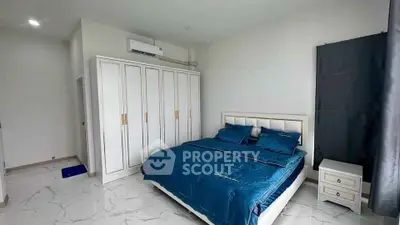 Spacious bedroom with elegant blue bedding and ample closet space