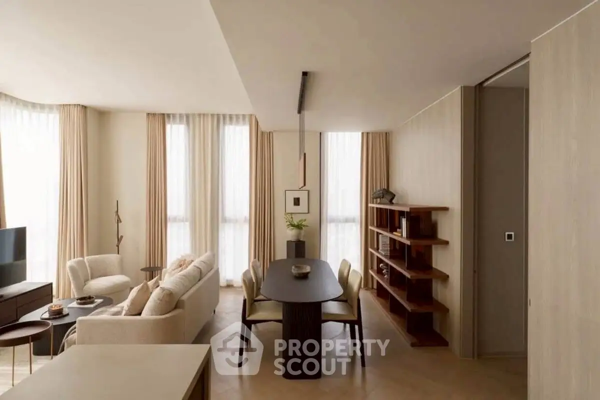 Elegant modern living room with dining area, featuring neutral tones and stylish furniture.