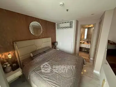 Luxurious bedroom with ensuite bathroom in modern apartment