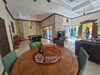 Spacious living room with pool table and elegant decor, perfect for entertaining.
