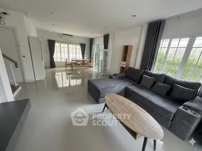 Spacious modern living room with large windows and stylish furniture
