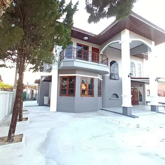 Stunning two-story house with elegant balcony and spacious driveway, perfect for family living.
