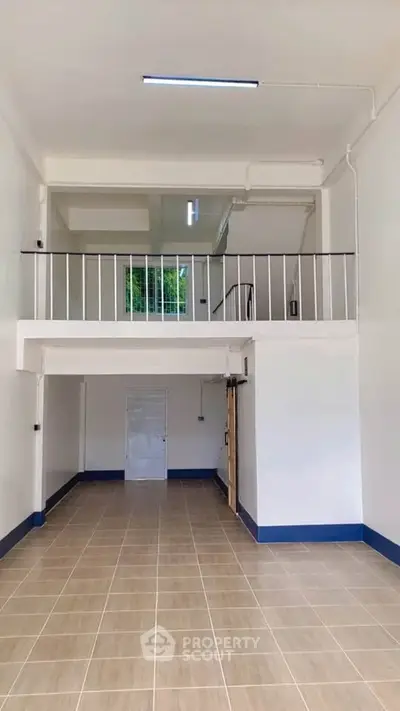 Spacious open-plan interior with mezzanine, ideal for modern living or office space.