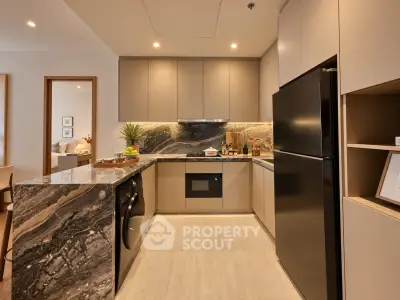 Modern kitchen with sleek cabinetry, marble countertops, and built-in appliances in a stylish apartment.