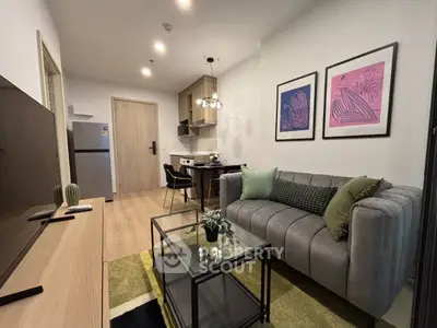 Modern living room with stylish decor, cozy sofa, and dining area in open-plan apartment.