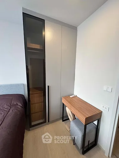 Modern bedroom with sleek wardrobe and stylish desk, perfect for urban living.