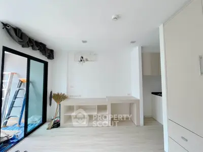 Modern unfurnished living room with large windows and built-in storage, ready for customization.