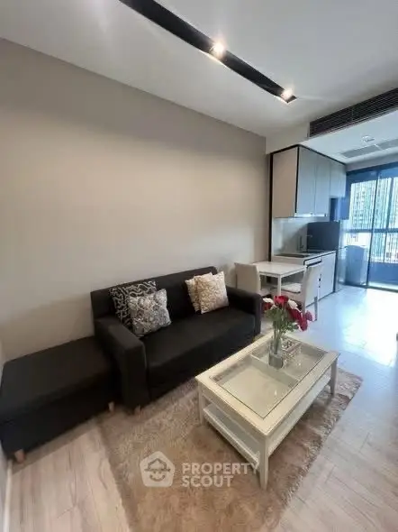 Modern living room with cozy sofa and open kitchen in stylish apartment