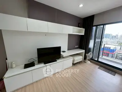 Modern living room with sleek white furniture and city view balcony, perfect for urban living.