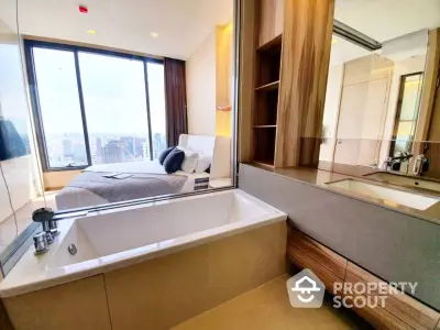 Luxurious bedroom with city view and modern ensuite bathroom featuring a sleek bathtub.