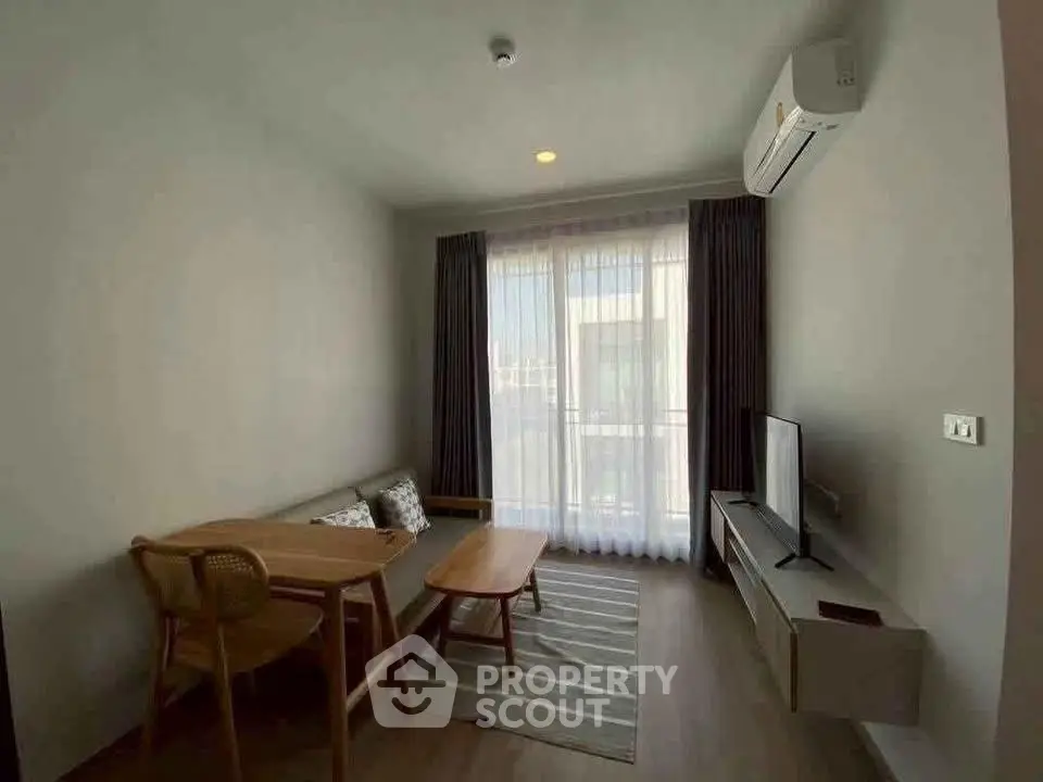 Cozy living room with modern furniture and natural light, perfect for relaxation and entertainment.