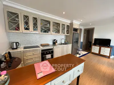 Spacious kitchen with modern appliances and open layout, featuring stylish cabinetry and ample counter space.