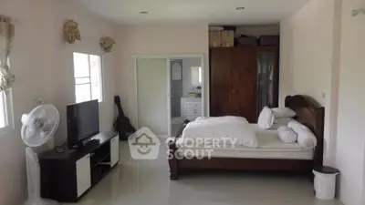Spacious bedroom with modern furnishings and natural light