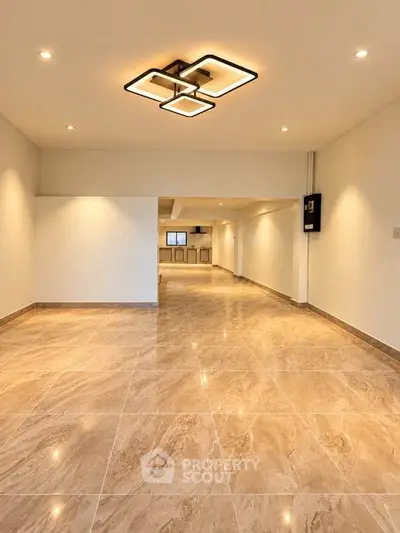 Spacious modern living room with elegant lighting and marble flooring