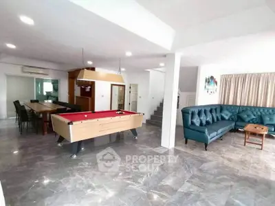 Spacious living room with pool table and modern decor