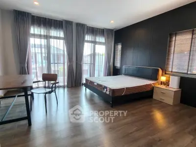 Spacious modern bedroom with large windows and stylish decor