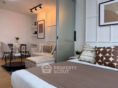 Modern studio apartment with stylish decor, featuring a cozy living area and dining space.