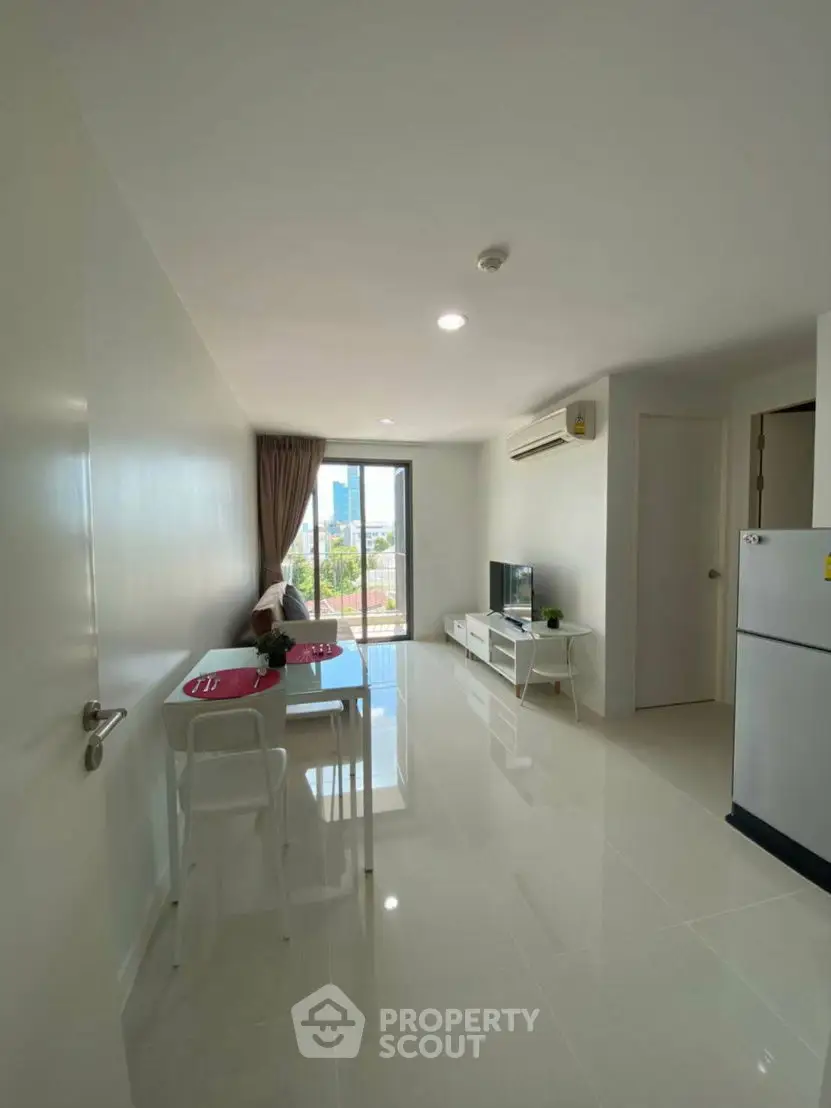 Modern living room with sleek design and city view from balcony