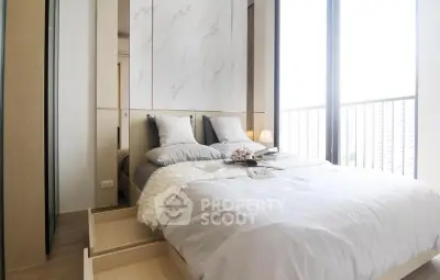 Modern bedroom with large windows and elegant decor in a high-rise apartment.