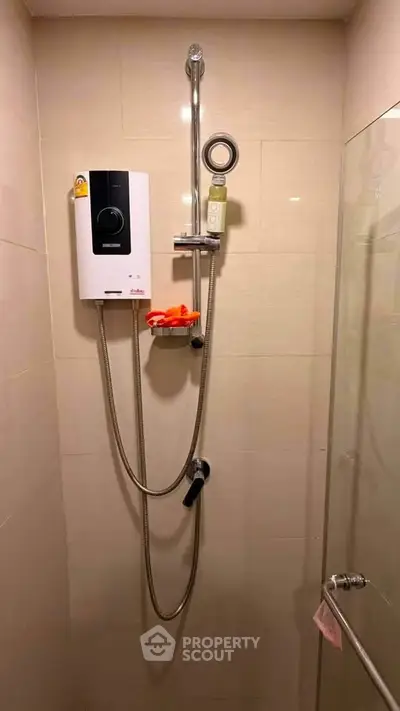 Modern bathroom shower with water heater and glass door