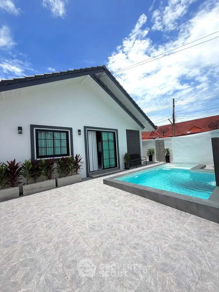 Modern house with private pool and stylish exterior design under a clear blue sky.