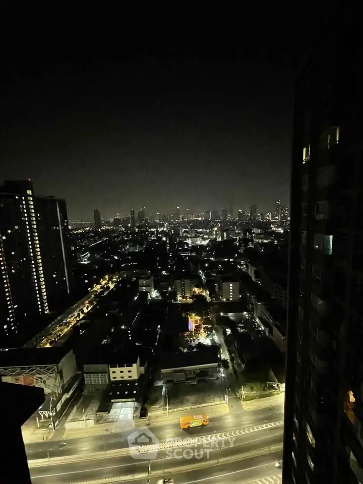 Stunning night cityscape view from high-rise building, showcasing vibrant urban lights and skyline.