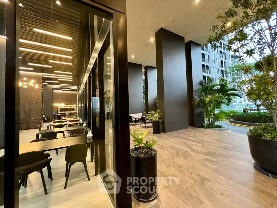 Luxurious modern building entrance with stylish interior and greenery