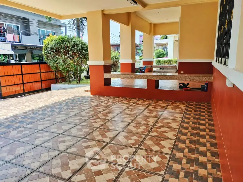 Spacious tiled patio with garden view and modern design