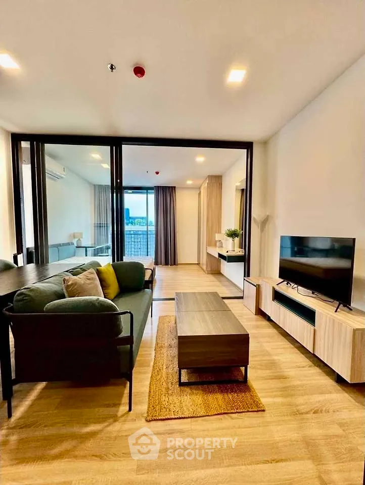 Modern living room with stylish furniture and large windows offering a stunning view.