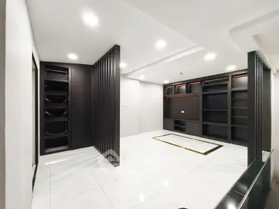 Spacious modern living room with sleek built-in shelving and bright lighting