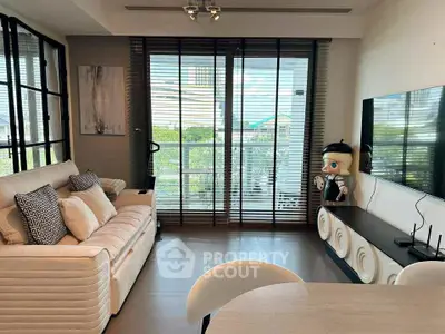 Modern living room with stylish decor and large windows offering natural light and scenic views.