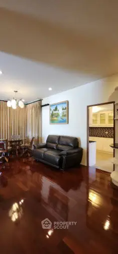 Spacious living room with polished wooden floors and elegant decor