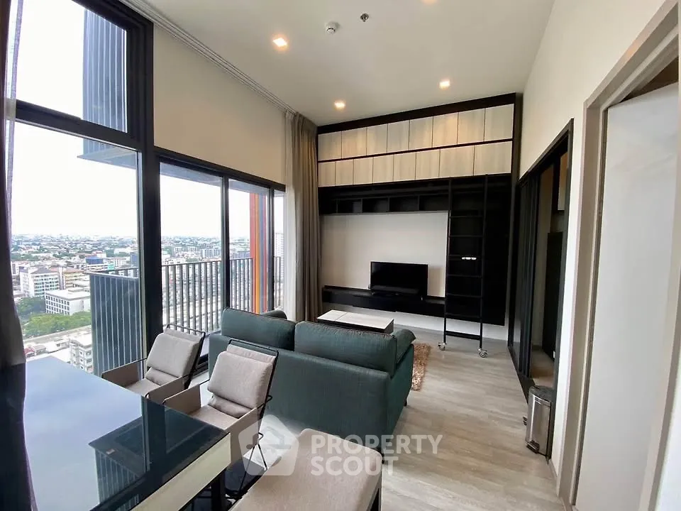 Modern living room with floor-to-ceiling windows and city view, featuring sleek furniture and built-in shelving.