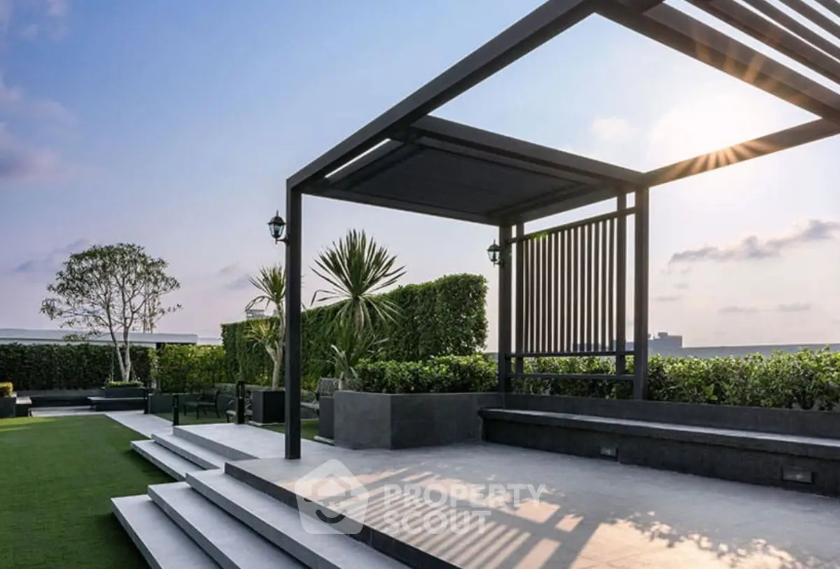 Stunning rooftop terrace with modern pergola and lush greenery, perfect for relaxation and entertainment.
