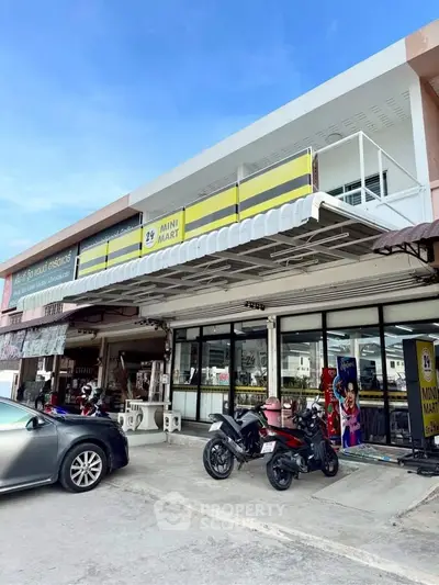 Charming mini mart exterior with ample parking and modern design, perfect for business opportunities.