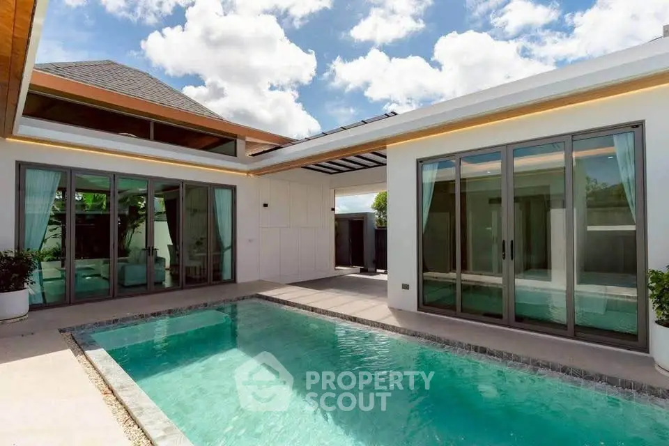 Luxurious modern villa with private pool and elegant architecture under a clear blue sky.