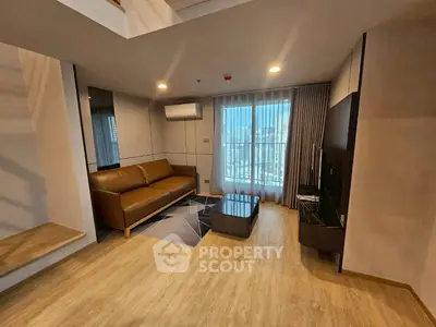 Modern living room with sleek furniture and city view balcony